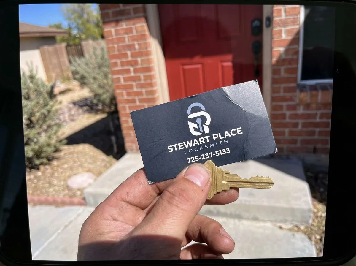 New house key held at a front door after lock rekeying in Las Vegas